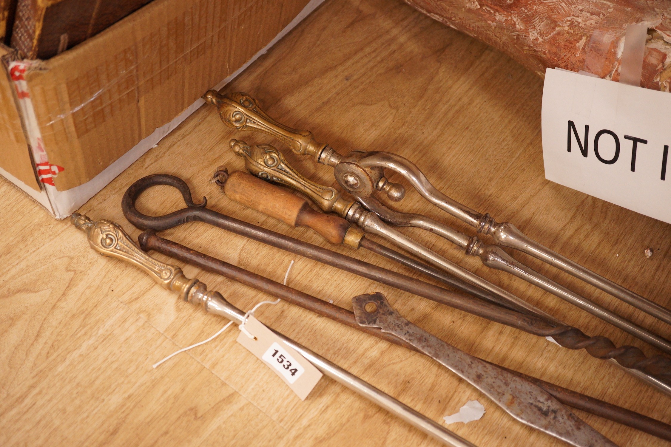 A set of three 19th century steel and brass fire irons and others